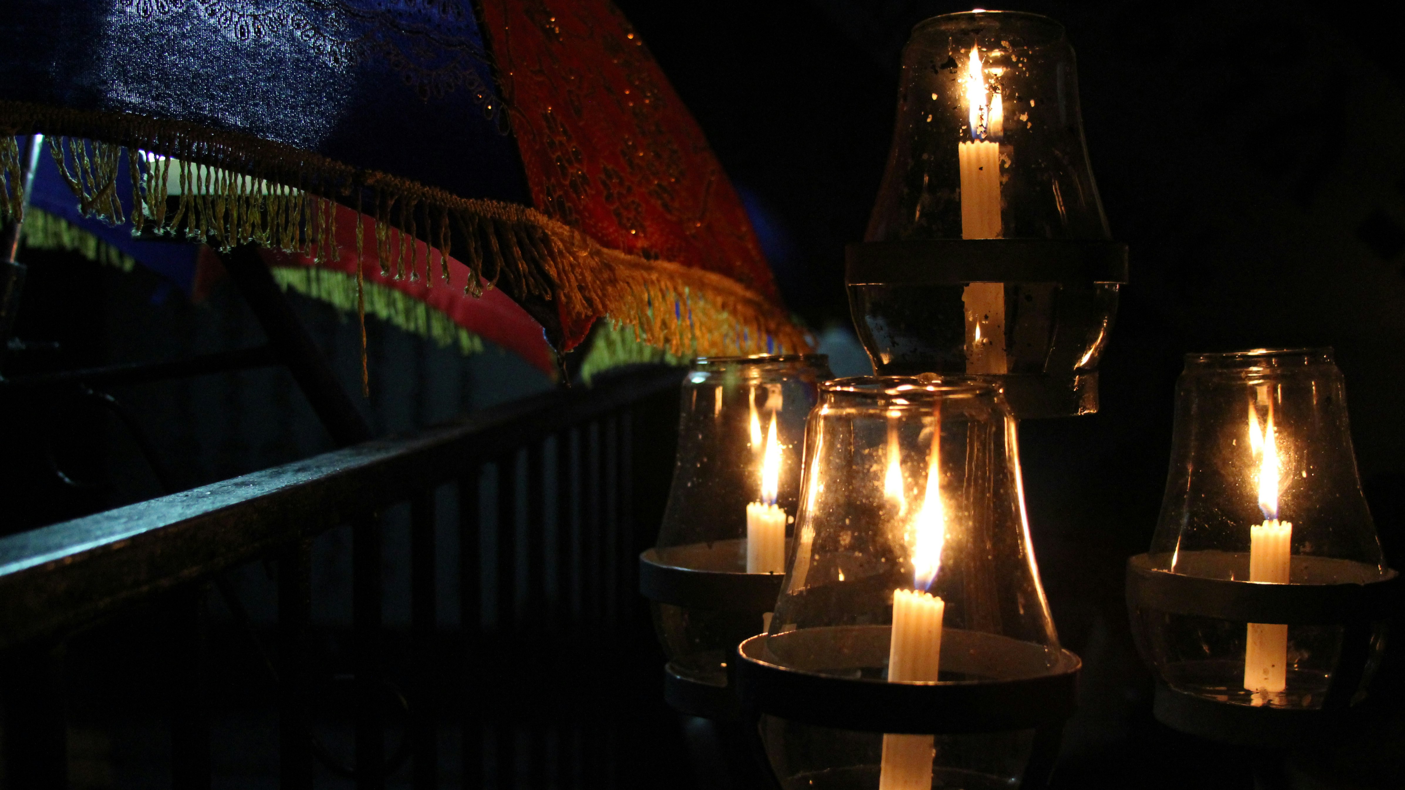 lighted candles on brown wooden stand